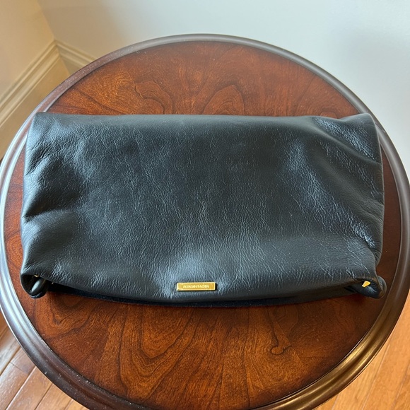 BCBGMaxAzria Handbags - BCBGMaxAzria Black Fold-Over Clutch with Gold Accent